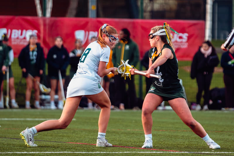 Two university lacrosse players competing for the ball in a BUCS fixture