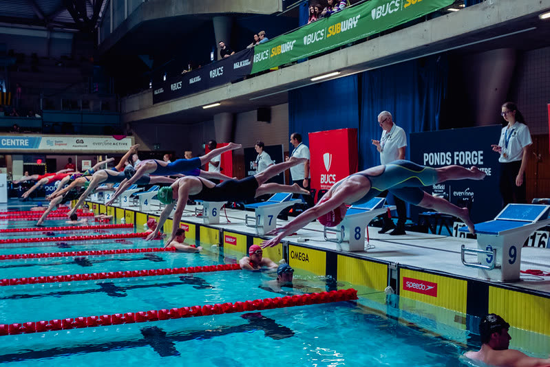 Swimmers diving from the blocks at a BUCS swimming championship